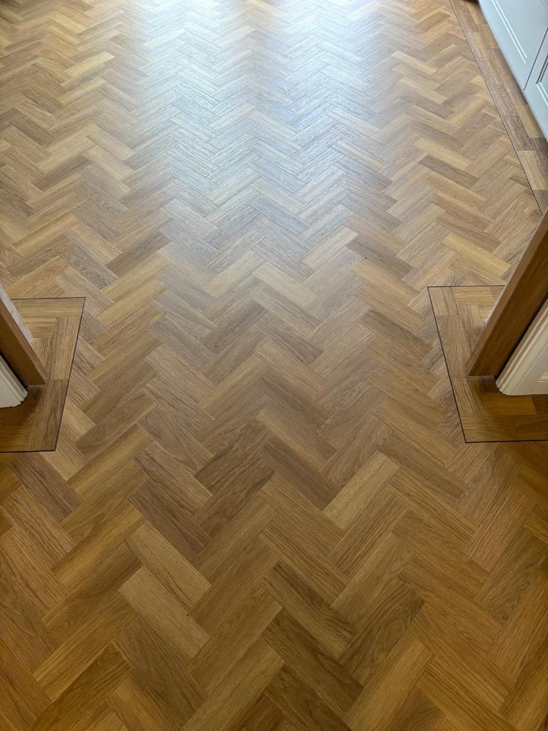 Herringbone LVT flooring installation with custom border — Parfait Flooring, Glasgow