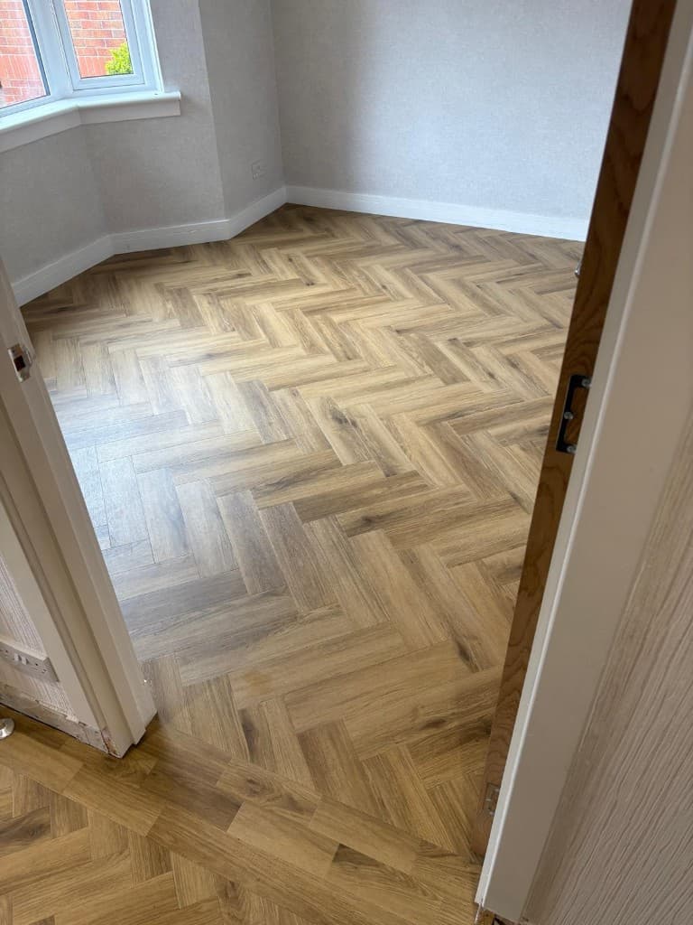 Herringbone LVT flooring installation with custom border — Parfait Flooring, Glasgow