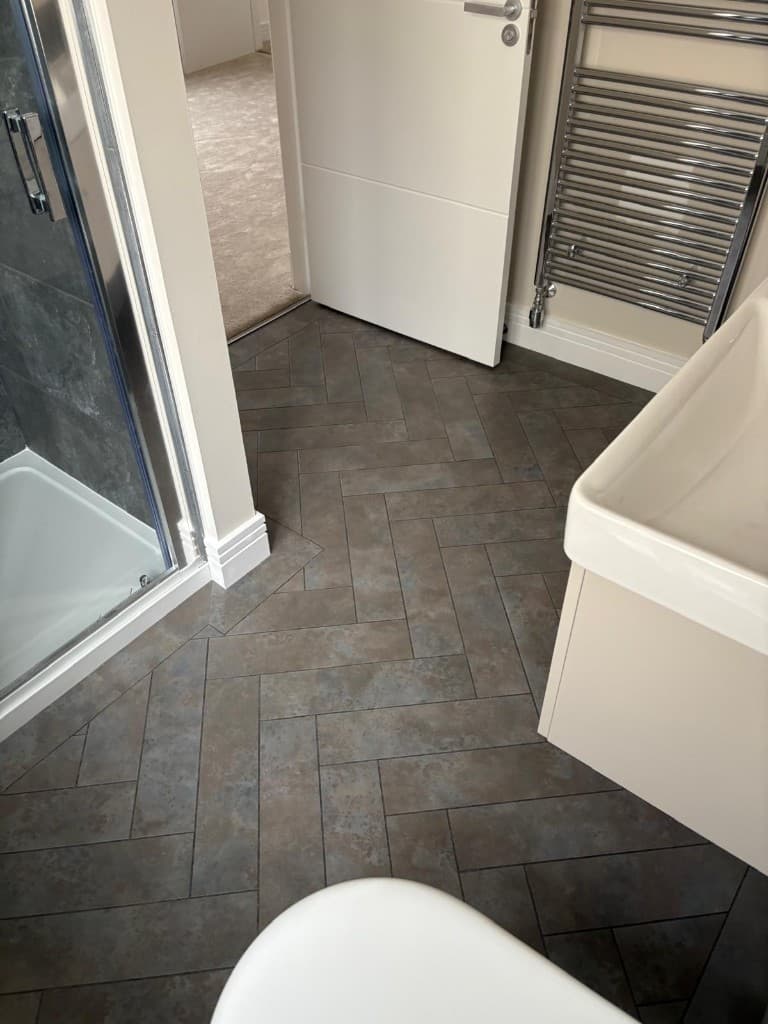 Herringbone LVT flooring installation with custom border — Parfait Flooring, Glasgow