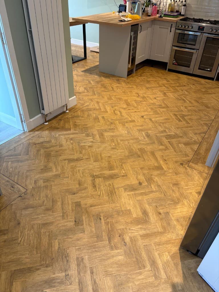 Herringbone LVT flooring installation with custom border — Parfait Flooring, Glasgow