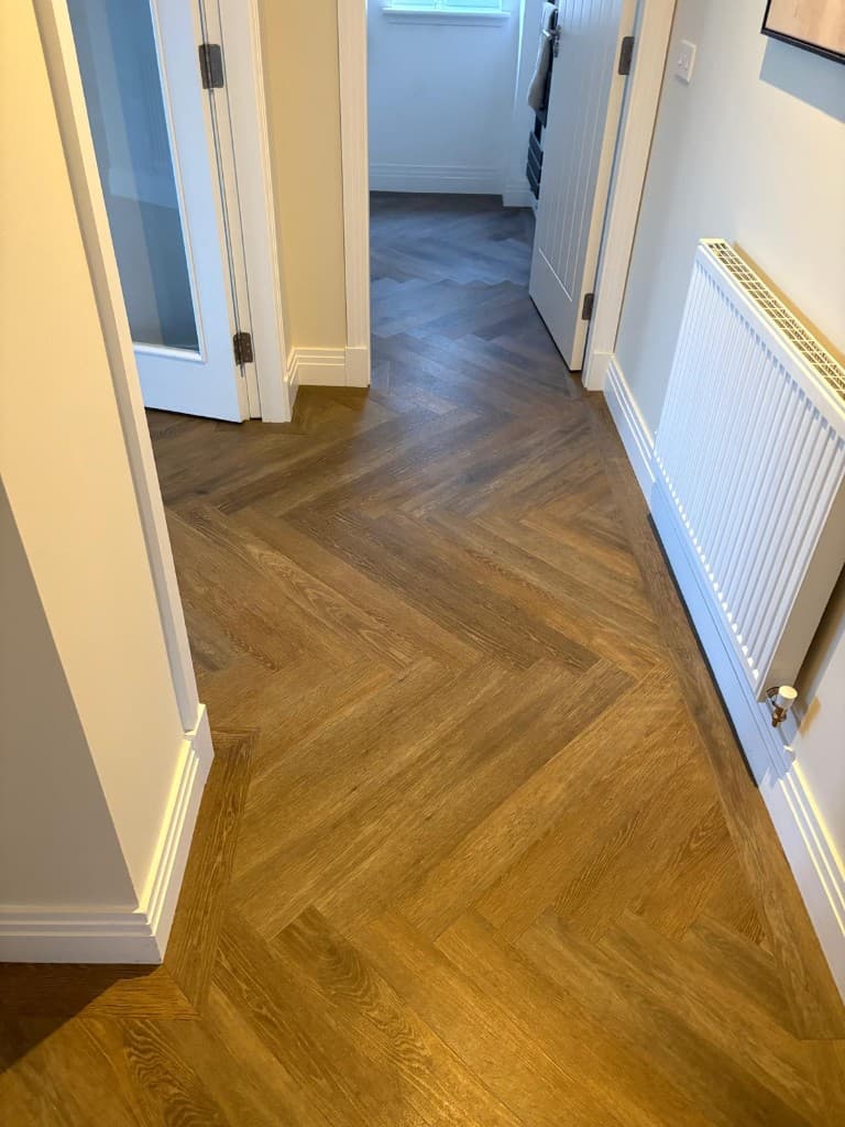 Herringbone LVT flooring installation with custom border — Parfait Flooring, Glasgow