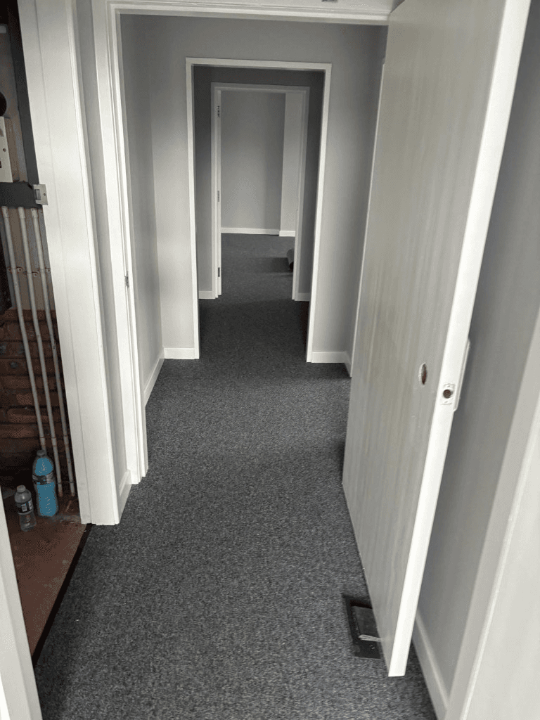 Dark carpet tiles fitted through a commercial corridor — Parfait Flooring, Glasgow